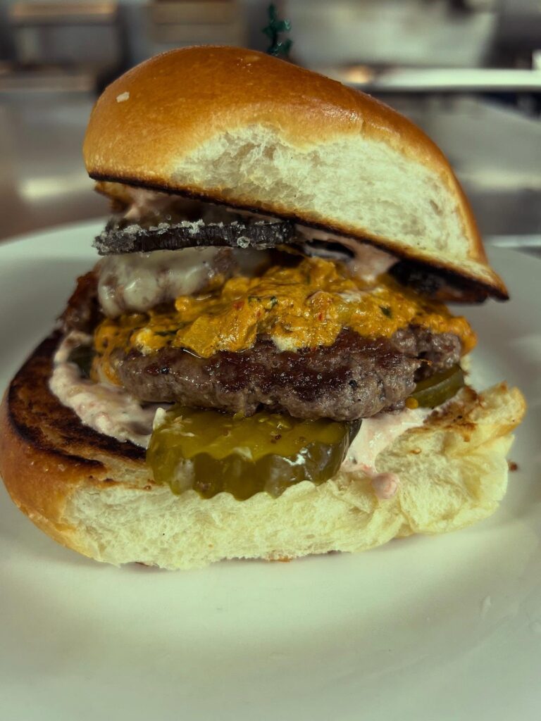Al-Pastor-Baja-Burger-w-Pineapple-Mole-Cream-Cheese,-Candies-Poblano,-Cilantro-Tomato-Sour-Cream,-Sweet-Hot-Pickles,-American-Cheese-Brewery-and-the-Beast-Deep-Creek-Lake